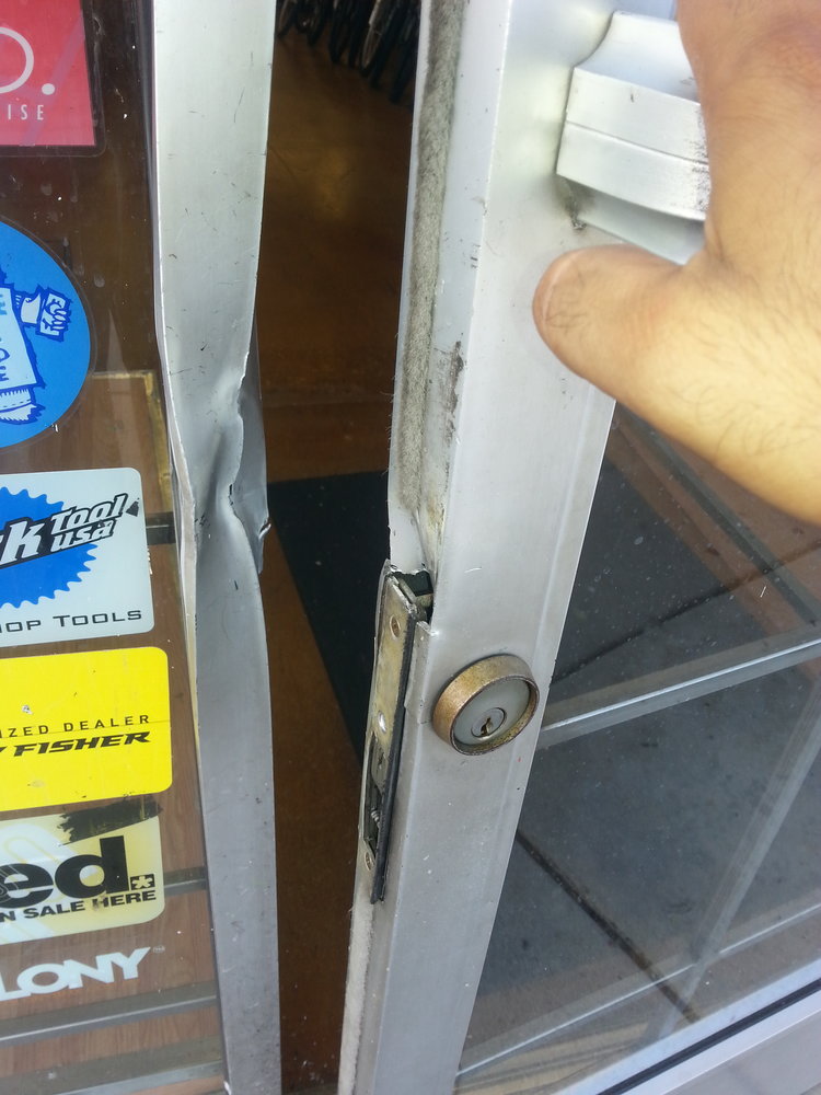 Example of a storefront door and frame damaged in a break-in robbery, Newhall CA