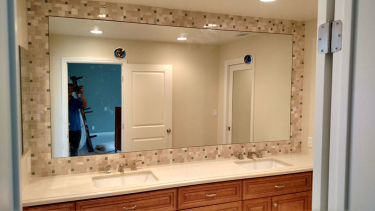 New bathroom vanity mirror with custom lamp fixture cutouts.