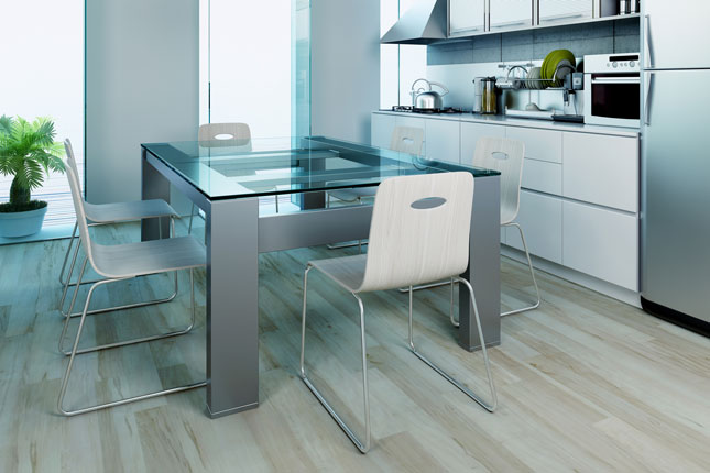 A heavy glass dining room table on a modern base.