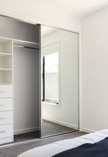 Chrome framed sliding wardrobe doors on a bedroom closet.