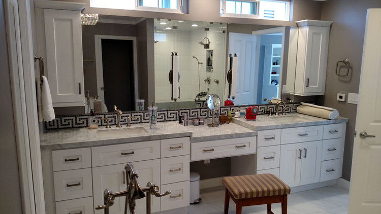 A custom vanity mirror installed above twin sinks.