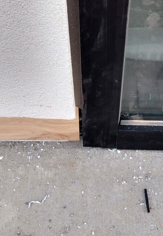 Sealant gap at bottom of storefront allowing water in the building.